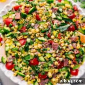 A close-up shot of the finished Italian Grinder Pasta Salad in a serving bowl, showcasing its rich colors and textures.