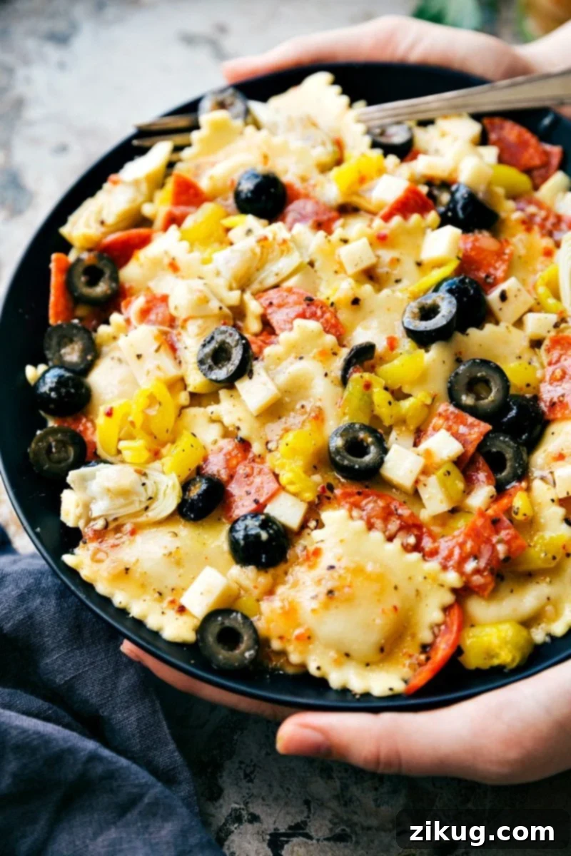 Vibrant Ravioli Salad 4 A bowl of Four Cheese Ravioli Salad, garnished and ready to be served at a summer party or potluck