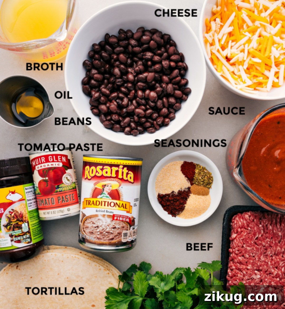 Carefully prepped ingredients for easy ground beef enchiladas, including seasoned beef, refried and black beans, enchilada sauce, tortillas, and shredded cheese.