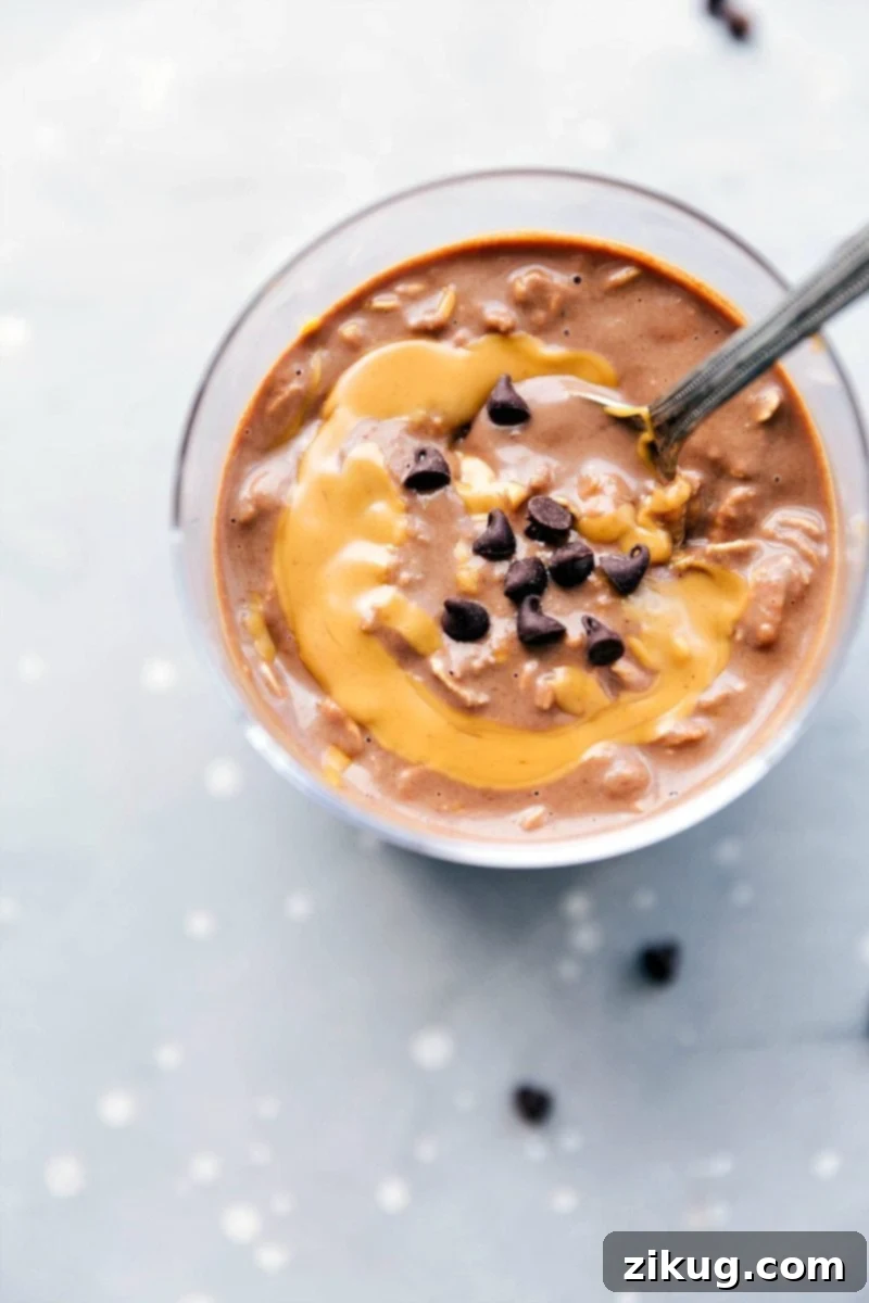 Peanut butter overnight oats, ready to be enjoyed on the go, with a peanut butter swirl mixed in and topped with chocolate chips.