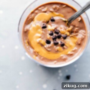 Peanut butter overnight oats, ready to be enjoyed on the go, with a peanut butter swirl mixed in and topped with chocolate chips.