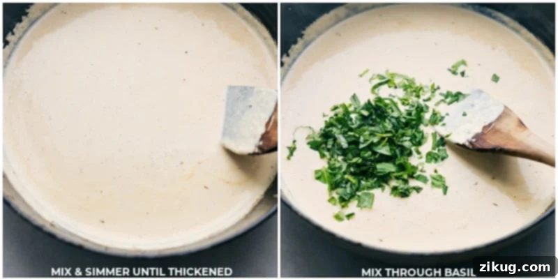 Close-up shot of the creamy chicken sauce reaching its perfect thickness in the skillet, with torn fresh basil leaves added, highlighting the vibrant green against the rich, golden sauce. A lemon wedge rests on the side.