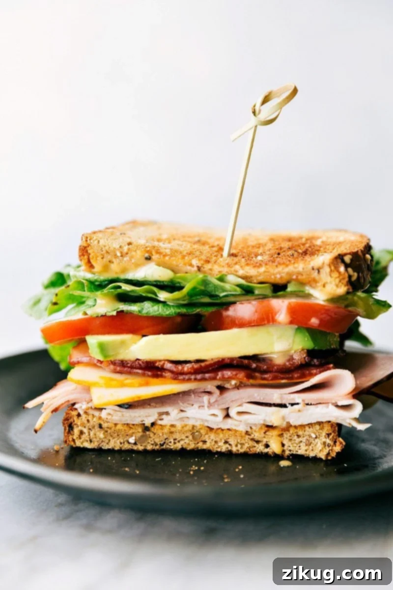 A delicious Honey Bacon Club Sandwich with all its layers visible, ready to be enjoyed.