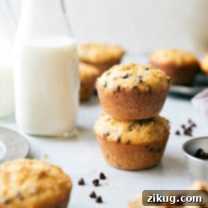 Close-up of a stack of healthy chocolate chip muffins, showing off their golden tops and mini chocolate chips.