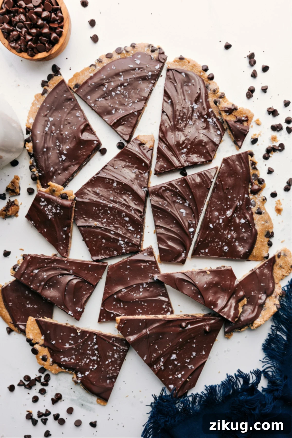 Irresistible Cookie Dough Bark covered in a smooth layer of chocolate, expertly broken into convenient, bite-sized pieces, perfectly arranged and ready for immediate enjoyment.