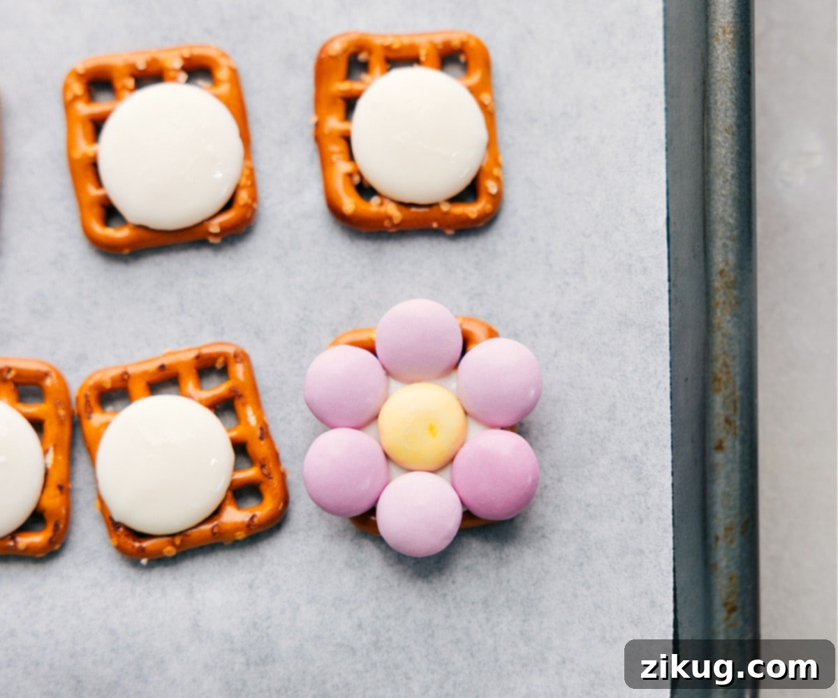 M&M's carefully placed on a softened candy melt atop a pretzel to form a vibrant, edible flower shape.
