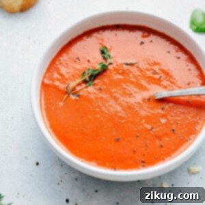Comforting Tomato Basil Soup 3 Tomato Basil Soup recipe in a bowl with fresh thyme.