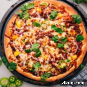 A delicious slice of BBQ Chicken Pizza, showcasing gooey melted cheese, tender chicken, and vibrant toppings, ready to be enjoyed.