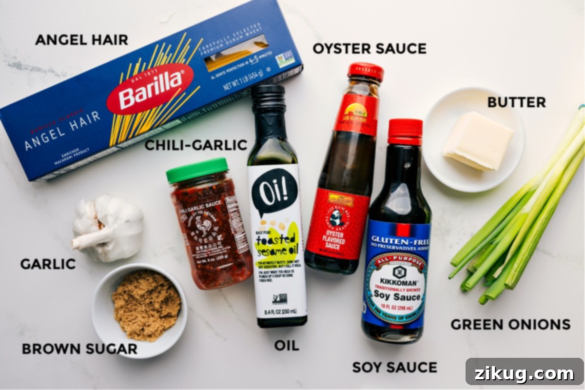 Key Ingredients For Flavorful Chili Garlic Noodles A vibrant flat lay showcasing all the fresh ingredients for Chili Garlic Noodles, including angel hair pasta, oyster sauce, butter, chopped green onions, soy sauce, cooking oil, chili garlic sauce, minced garlic, and brown sugar, neatly arranged and ready for cooking.