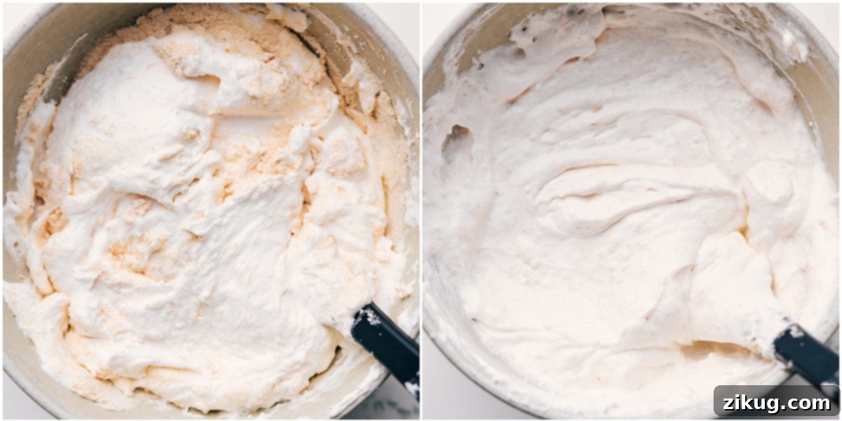 A close-up view of fluffy white whipped cream being gently folded with vanilla protein powder in a mixing bowl, illustrating the process of creating the creamy, protein-rich filling for the frozen s'mores.