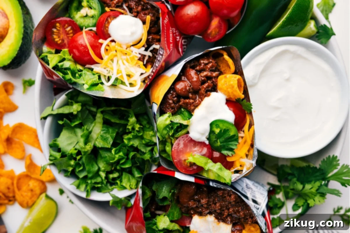A vibrant display of walking tacos, perfectly filled with seasoned beef and fresh toppings in individual chip bags, promising a delicious and mess-free dinner for summer gatherings.