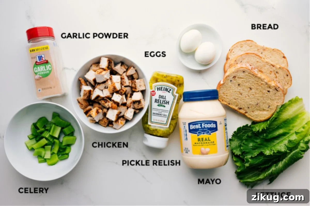 Ingredients In Chick-Fil-A Chicken Salad Recipe All ingredients for Chick-Fil-A Chicken Salad Recipe meticulously prepped and arranged, including cooked chicken, fresh celery, sweet pickle relish, mayonnaise, hard-boiled eggs, sliced bread, and crisp lettuce.
