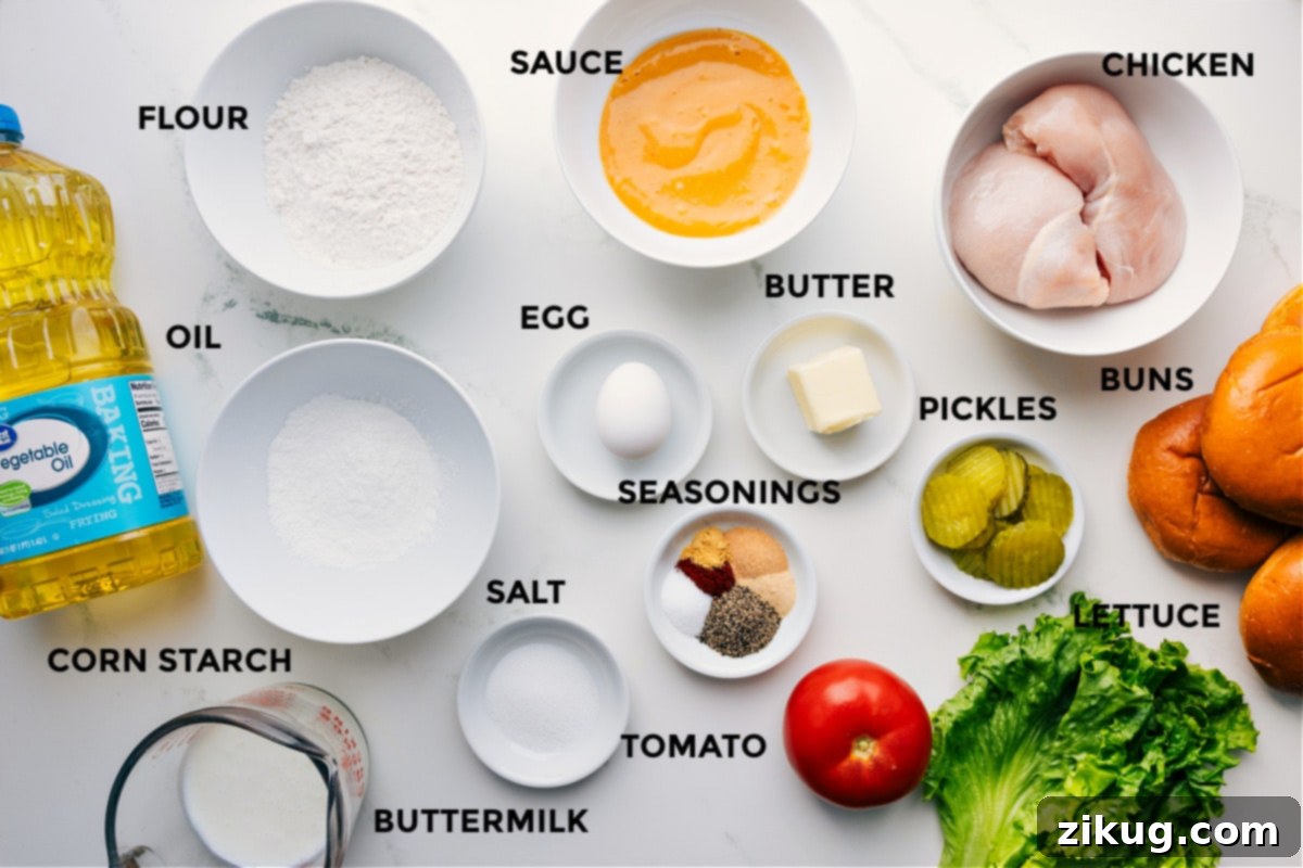 All the ingredients prepped and ready for crispy chicken sandwich assembly, including oil, cornstarch, flour, sauce, egg, seasonings, salt, tomato, butter, pickles, lettuce, chicken, and buns.