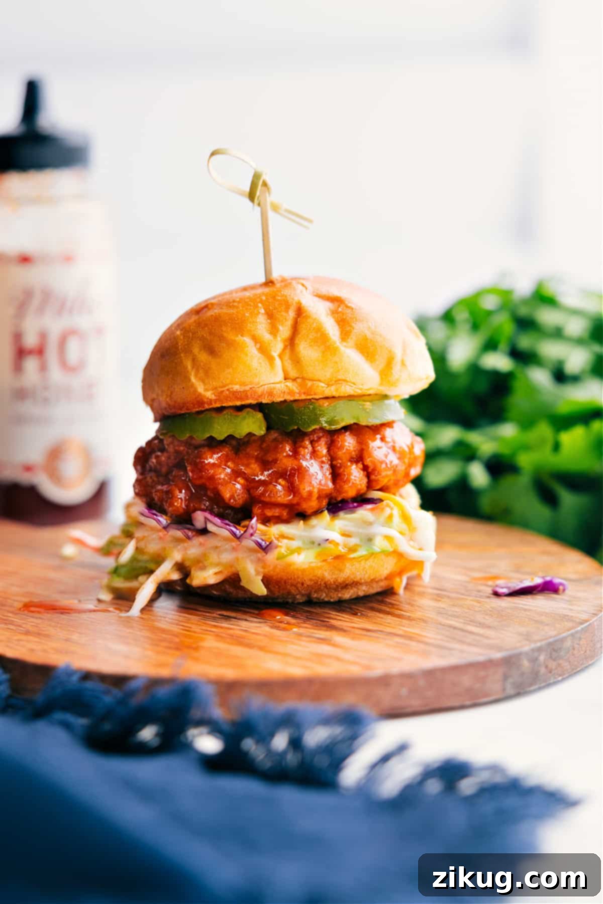 Hot Honey Chicken Sliders layered with creamy coleslaw and tangy pickles on soft brioche slider buns, ready to be served.