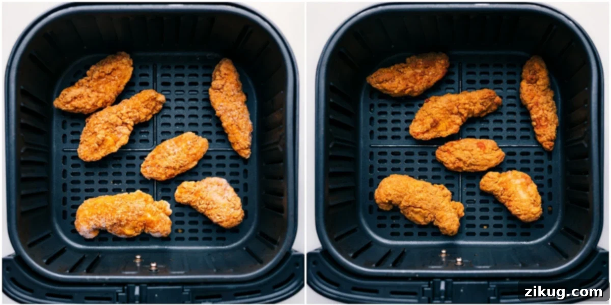 Crispy chicken tenders being carefully air-fried to a golden perfection, preparing them for the hot honey sauce in a slider recipe.