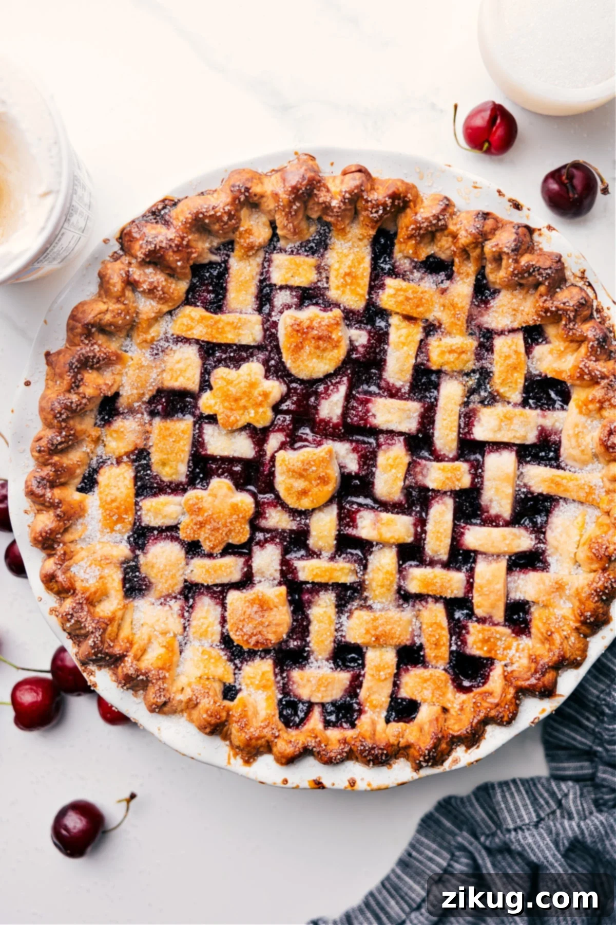 Golden-brown cherry pie recipe just out of the oven, waiting to be cut. Steam gently rises from the freshly baked crust.