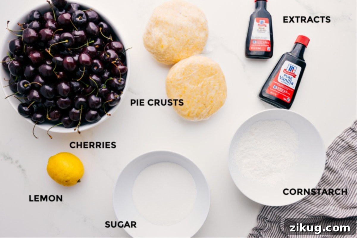 Prepped ingredients for this cherry pie recipe including fresh cherries, pie crusts, lemon, granulated sugar, cornstarch, butter, vanilla extract, almond extract, and sparkling sugar.