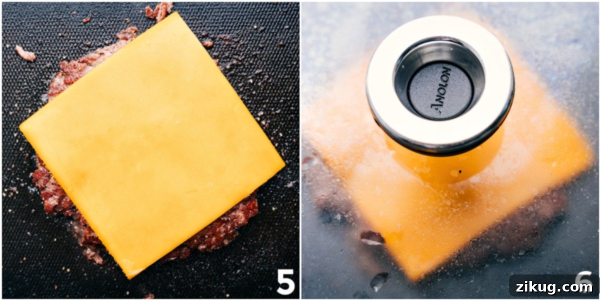 A sizzling smashburger patty on the griddle with a slice of sharp cheddar cheese melting perfectly over its crispy edges, ready for assembly.