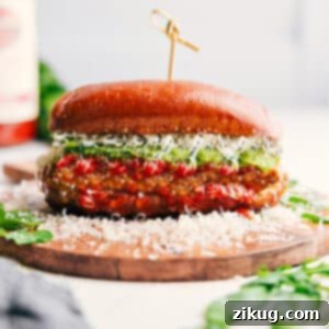 A close-up of a delicious Chicken Parmesan Sandwich, highlighting its crispy chicken, melted cheese, and fresh pesto, making it look irresistible.