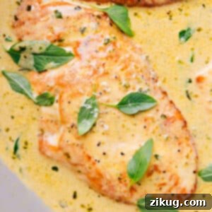 Creamy Pesto Chicken in a skillet with basil garnish.
