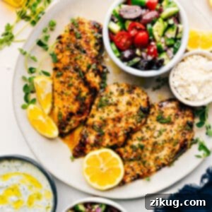 Platter of grilled Greek chicken with lemon and herbs.