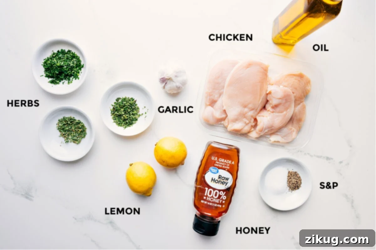Ingredients In Greek Chicken Marinade All the ingredients in this recipe prepped out for easy assembly including the herbs, lemon, garlic, chicken, honey, and oil.