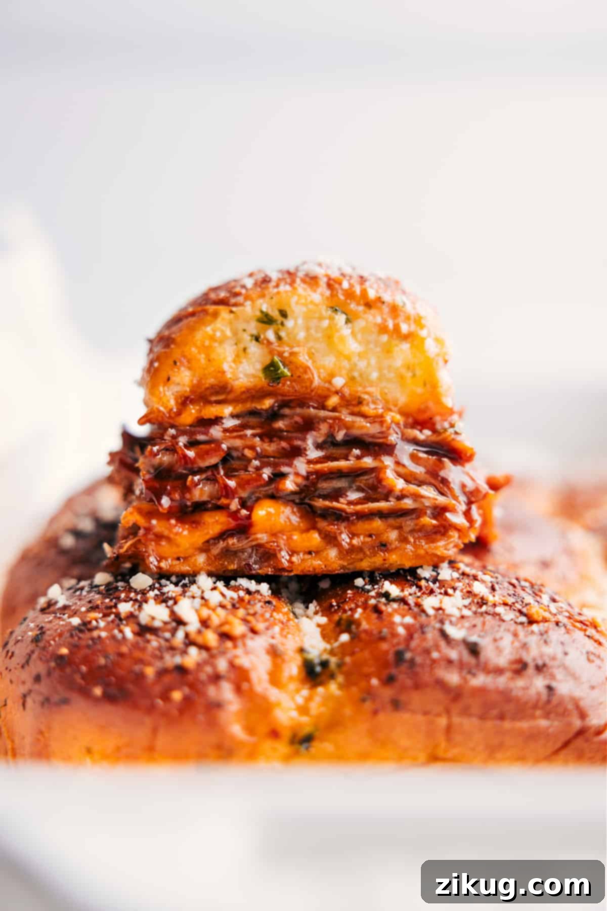 Delicious BBQ Pulled Pork Sliders for Any Occasion A stack of golden brown BBQ Pulled Pork Sliders, revealing layers of melted cheese and succulent pulled pork, ready to be served on a platter.
