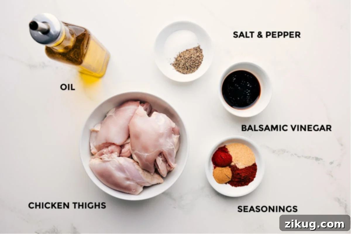 Ingredients In Baked Chicken Thighs All essential ingredients for the baked chicken thigh recipe laid out: boneless skinless chicken thighs, olive oil, balsamic vinegar, chili powder, cumin, garlic powder, paprika, salt, and pepper.