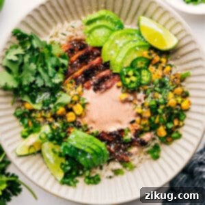 A close-up of the finished Street Corn Chicken Rice Bowl, showcasing its vibrant ingredients and creamy sauce.