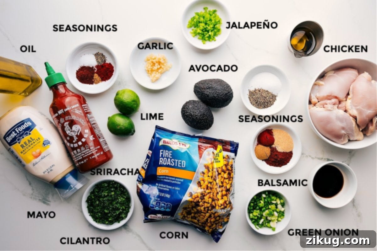 Key Ingredients For Your Homemade Street Corn Chicken Rice Bowl All the fresh ingredients for the Street Corn Chicken Rice Bowl laid out: mayo, cilantro, various seasonings, lime, garlic, jalapeno, balsamic, chicken, avocado, oil, green onions, and corn.