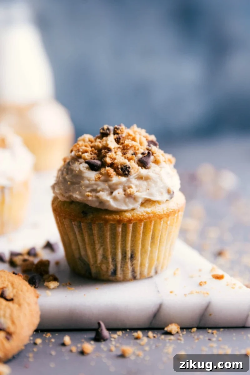 Indulgent Chocolate Chip Cupcake with Luscious Icing and Chocolate Toppings Decadent chocolate chip cupcakes topped with luscious cream cheese icing and sprinkled with chocolate cookie shavings.