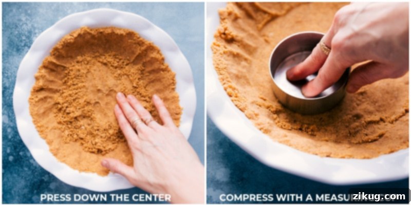Process shot of pressing the graham cracker crust firmly into the pie pan using a measuring cup.