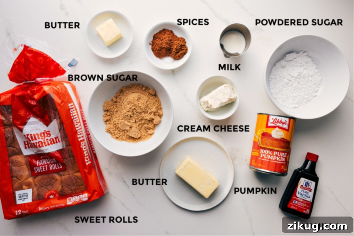 All the ingredients in this recipe prepped out for easy assembly: rolls, butter, brown sugar, spices, cream cheese, milk, powdered sugar, pumpkin, and vanilla.
