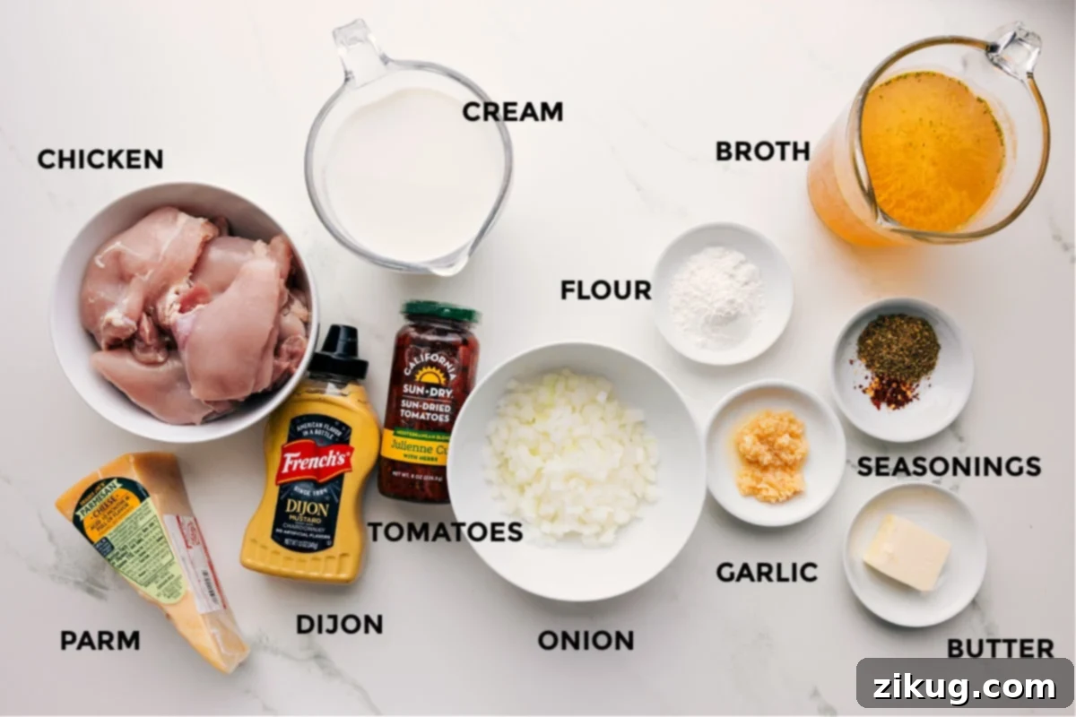 All the ingredients prepped for easy assembly, including chicken, Parmesan, Dijon, cream, tomatoes, onion, flour, garlic, seasonings, butter, and broth.