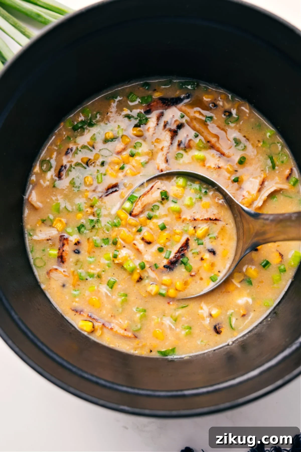 Simple One Pot Chicken Corn Soup Recipe A hearty pot of Chicken Corn Soup, rich in golden color, with a ladle scooping a generous portion.