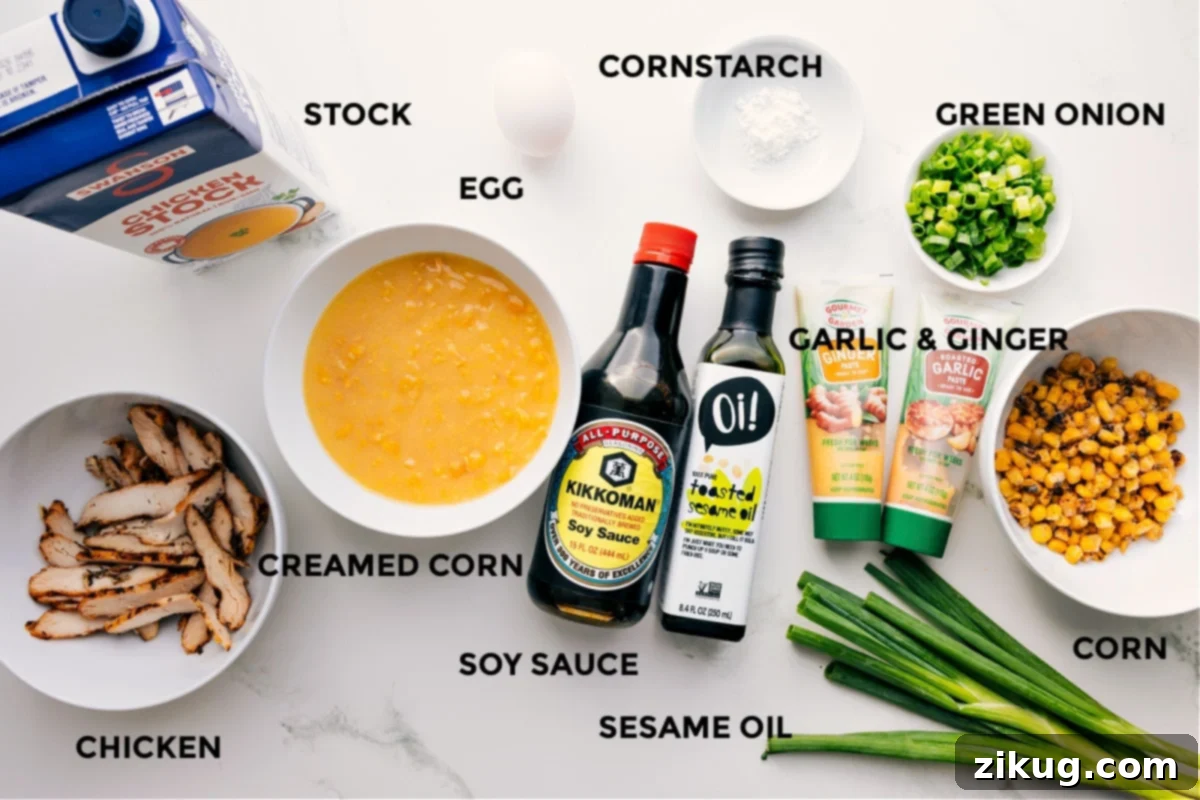 Ingredients In Chicken Corn Soup Recipe All the ingredients for Chicken Corn Soup recipe are neatly prepped out for easy assembly, including chicken stock, creamed corn, frozen corn, soy sauce, toasted sesame oil, garlic paste, ginger paste, whisked egg, cornstarch slurry, shredded cooked chicken, green onions, and seasonings.