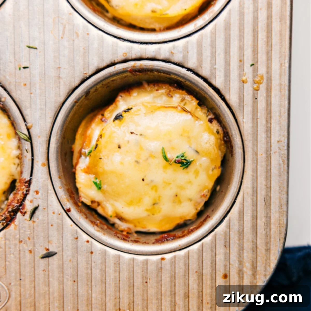 The Ultimate Appetizer Or Side: Irresistible Potato Stacks Recipe Individual potato stacks recipe baked to golden perfection in a muffin tin, garnished with fresh herbs and ready to be served as an ultimate appetizer or side dish.