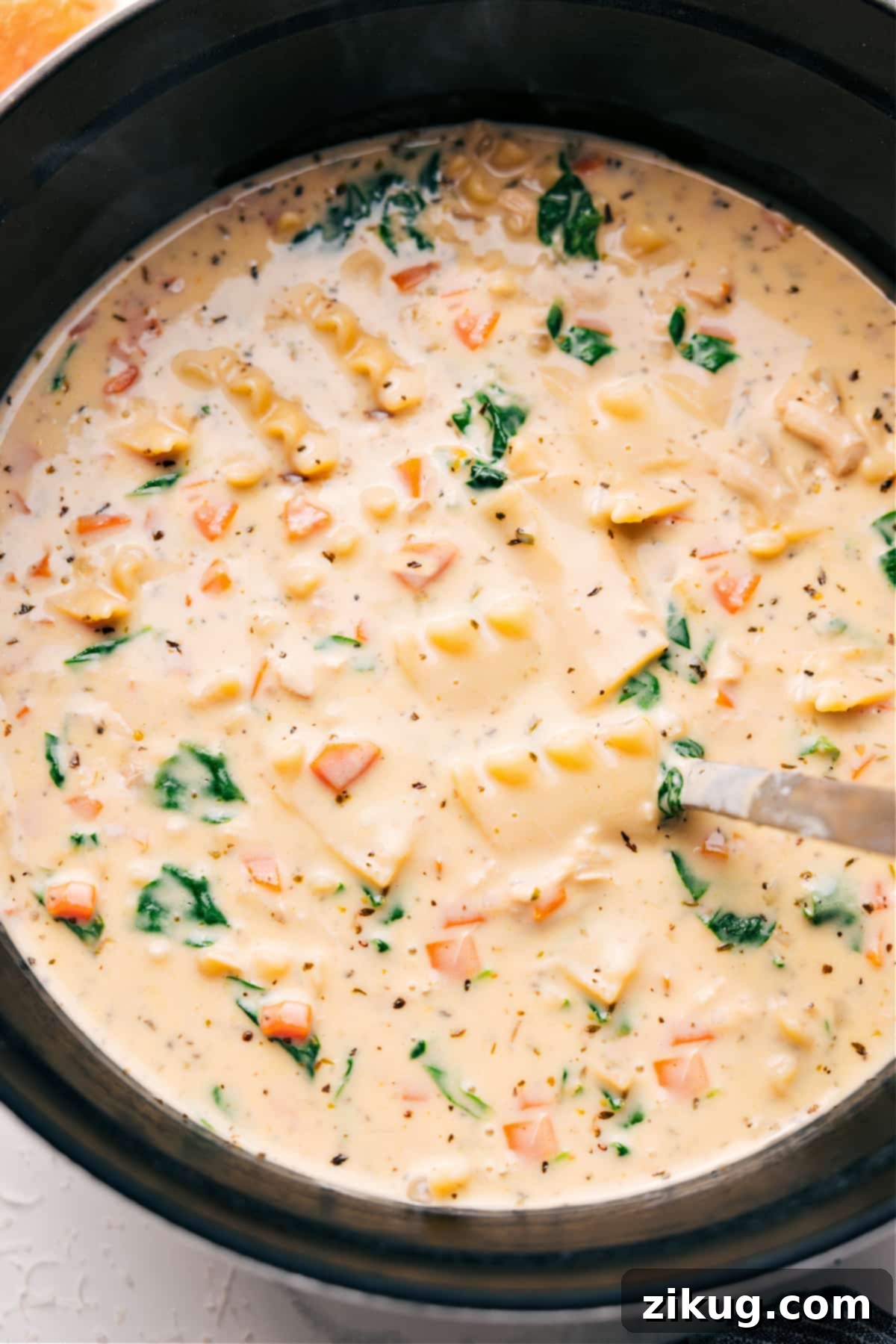Creamy White Chicken Lasagna Soup in a Pot A large pot of White Chicken Lasagna Soup, garnished with fresh herbs and grated cheese, ready to be served.