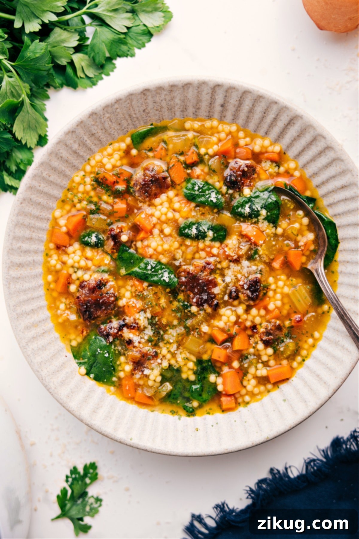 The Ultimate Comfort Food: Irresistible Italian Wedding Soup Recipe Italian Wedding Soup Recipe served in a bowl with a spoon, highlighting the rich broth, meatballs, pasta, and vibrant greens.