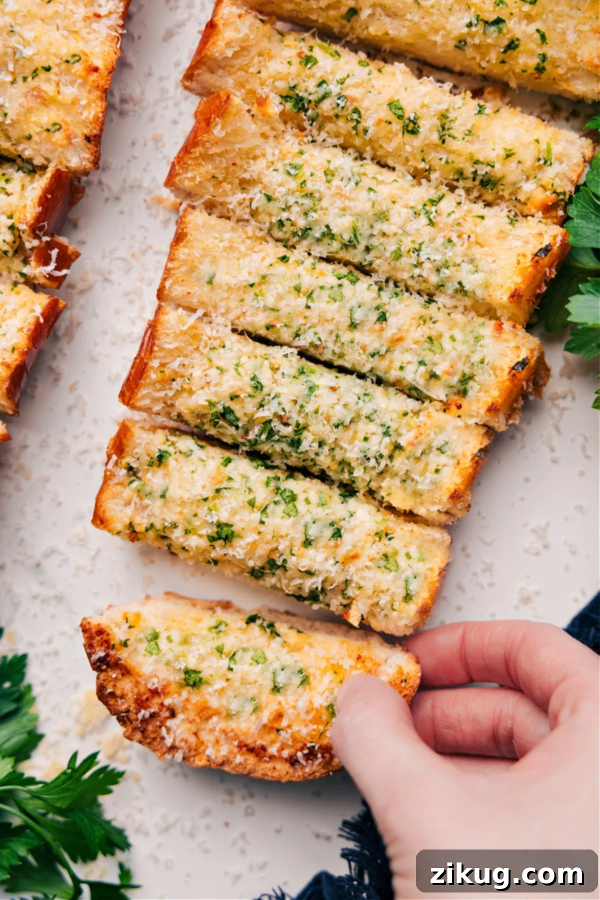 Comforting And Delicious Garlic Bread Recipe Golden brown garlic bread slices, topped with fresh Parmesan, ready to serve.
