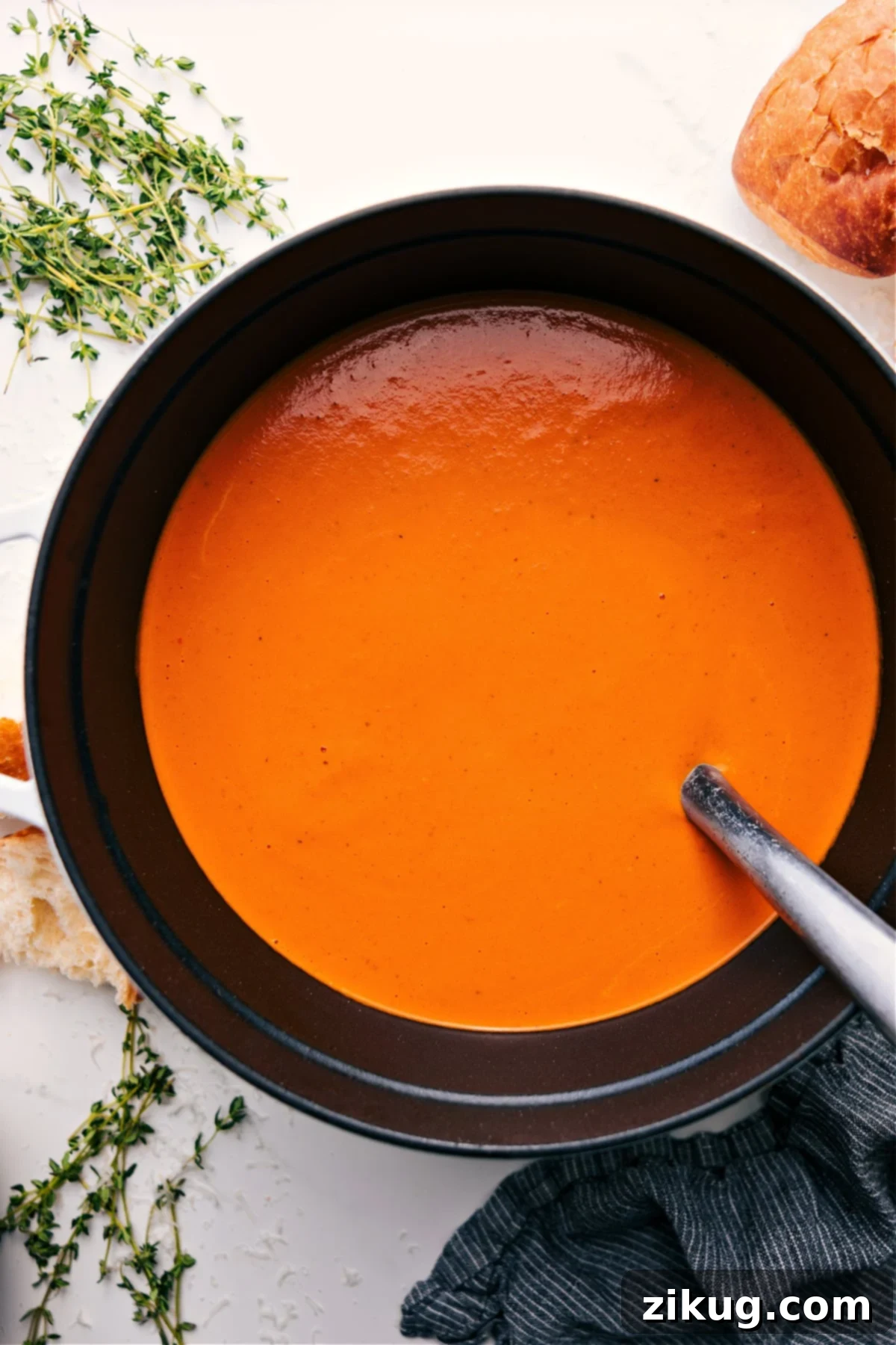 Roasted Red Pepper Gouda Soup Is The Most Comforting Thing You'll Have All Month Roasted Red Pepper Gouda Soup in the pot ready to be enjoyed, garnished with fresh herbs.