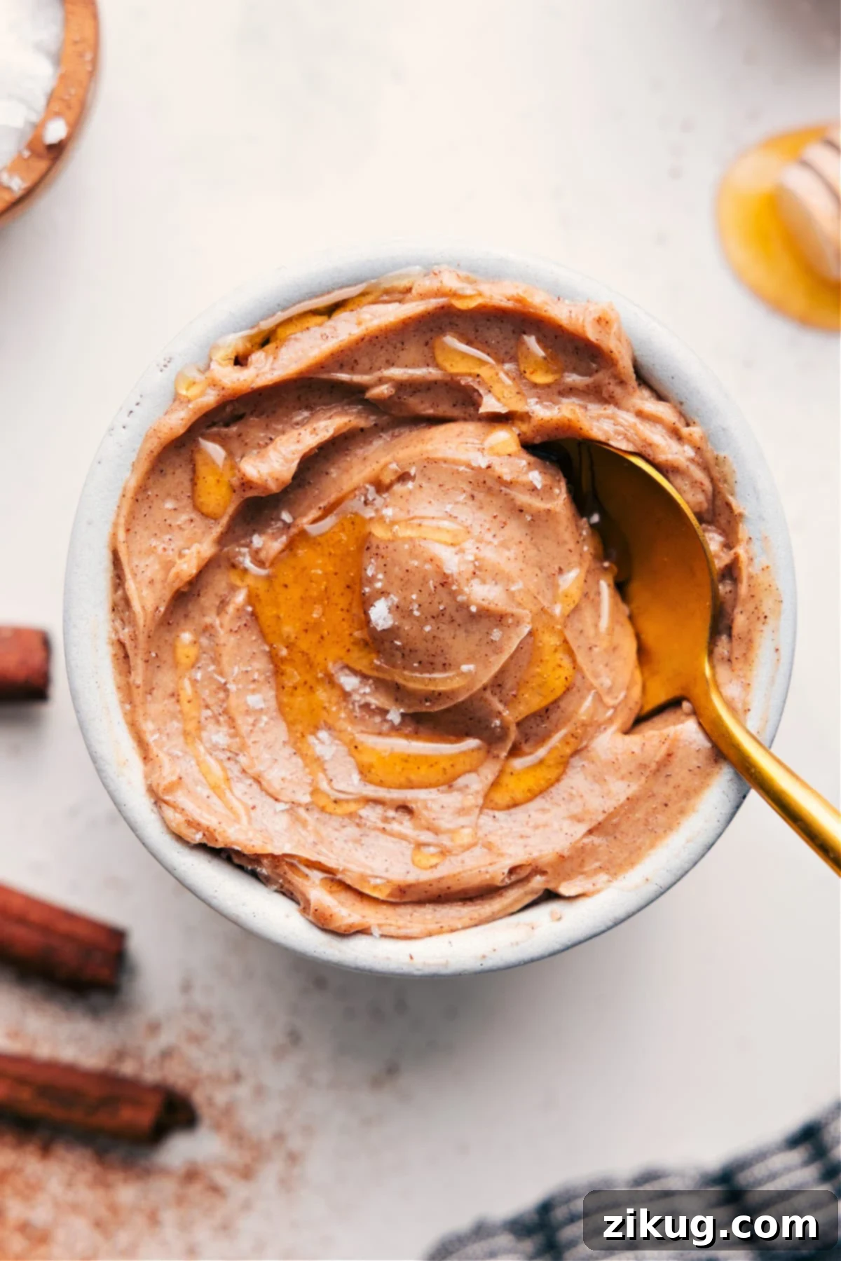 Irresistible Creamy Honey Butter Recipe Creamy homemade honey butter in a decorative bowl with an extra honey swirl and a sprinkle of flaky sea salt, ready to be served.