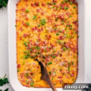 A close-up shot of the golden-brown, creamy Corn Pudding Casserole in a serving dish, ready to be enjoyed.