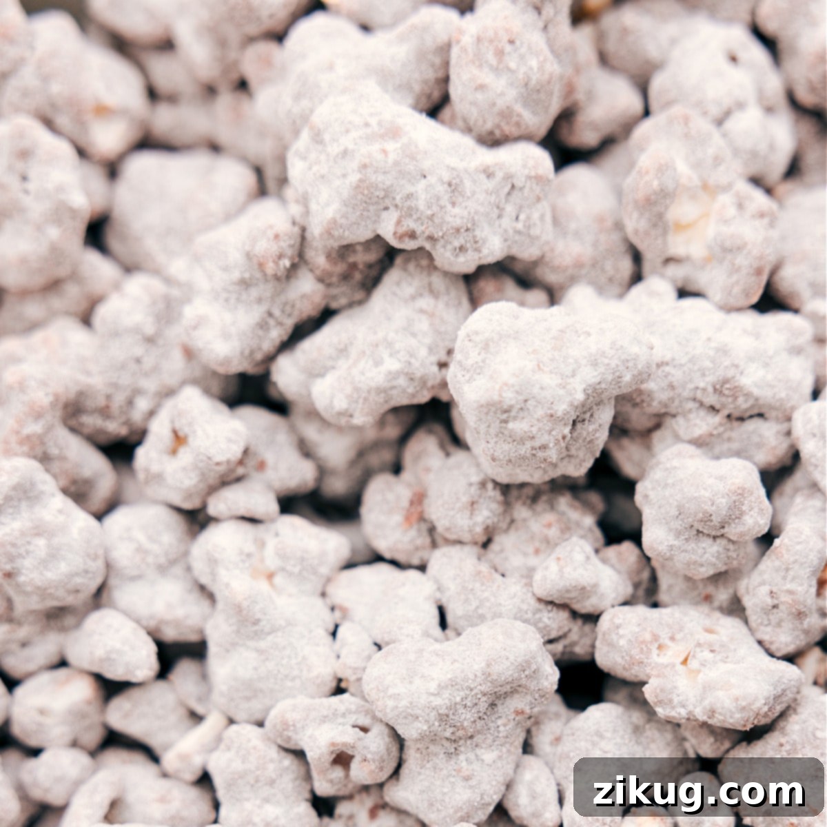A large bowl of freshly prepared Popcorn Puppy Chow, beautifully coated and ready to be served as an ultimate sweet and crunchy snack.