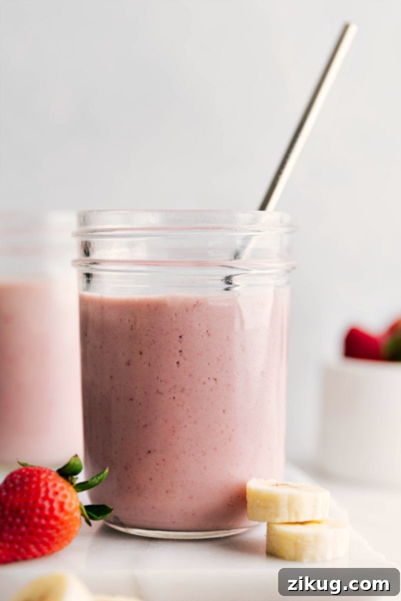 Savor the moment with this exquisite Strawberry Banana Smoothie, a perfect fusion of health and indulgence. Its creamy consistency and refreshing flavor make it an ideal quick breakfast, energizing snack, or post-workout treat, crafted with simple, wholesome ingredients. Up-close shot of a perfectly blended Strawberry Banana Smoothie, showcasing its smooth, creamy texture and refreshing appeal.
