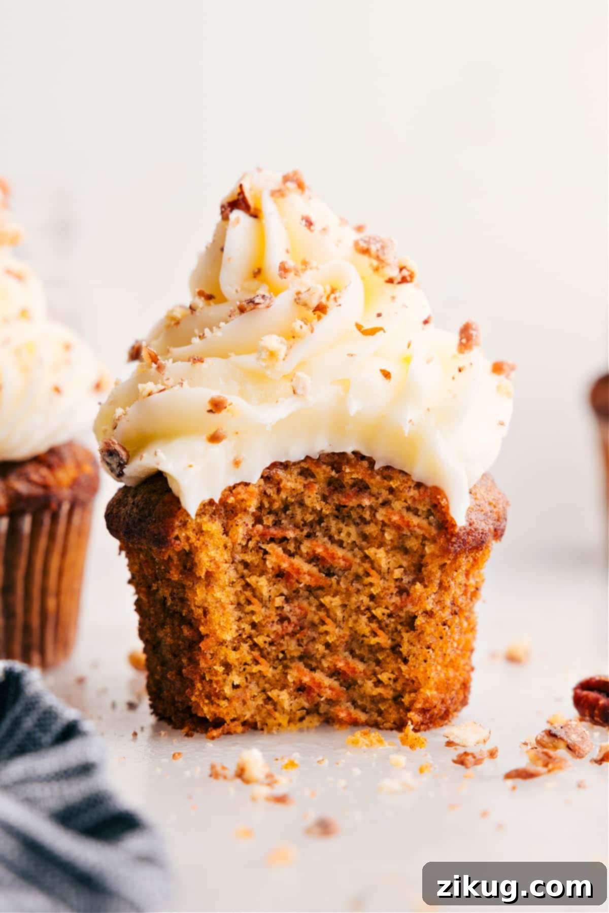 Spiced Carrot Cupcakes 3 A carrot cake muffin with a bite taken out, showing the moist interior.
