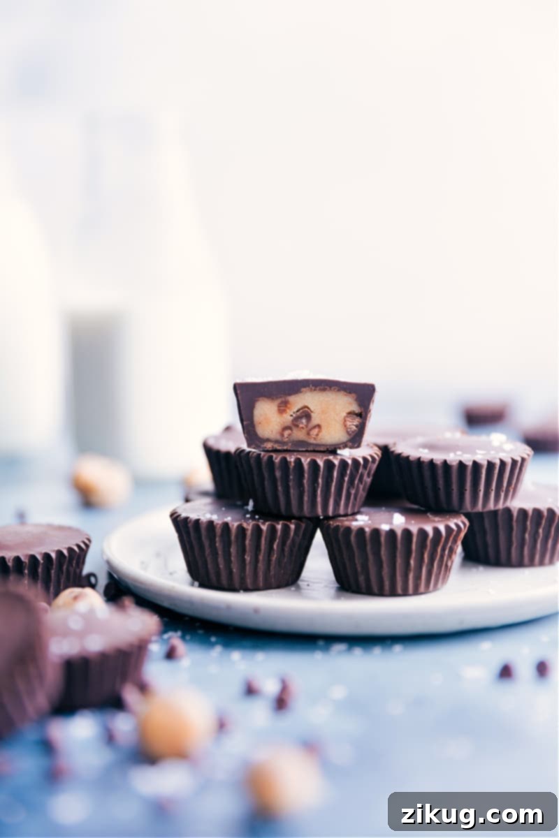 Homemade Edible Cookie Dough Cups Delicious homemade Cookie Dough Cups, a chocolate shell filled with edible cookie dough, resembling a mini Reese's cup.