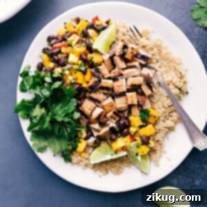 Delicious quinoa chicken bowl with fresh mango salsa and cilantro on the side.