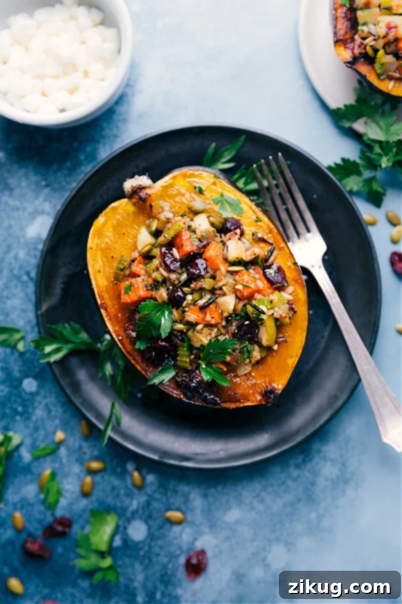 This Stuffed Acorn Squash starts with perfectly roasted and slightly caramelized acorn squash which gets loaded up with seasoned wild rice, tender sweet potatoes, crisp green apples, and more! This is nutritious warming comfort food at its best! Recipe via ChelseasMessyApron #dinner #fall #quick #easy #simple #clean #whole #best #sweetpotato #stuffed #acornsquash Stuffed Acorn Squash with perfectly roasted and slightly caramelized acorn squash loaded with seasoned wild rice, tender sweet potatoes, and crisp green apples.