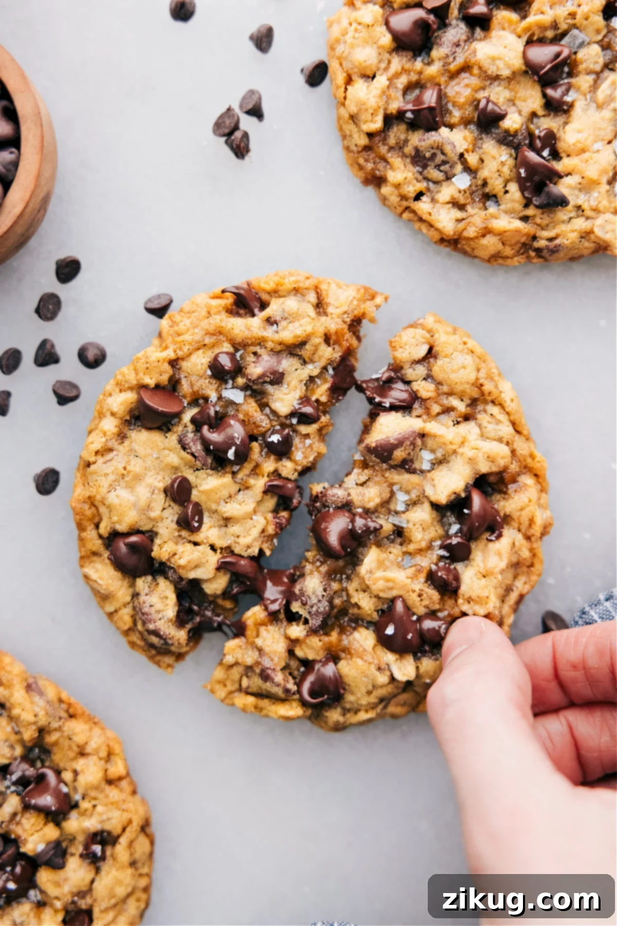 Single Serve Chocolate Chip Oatmeal Cookies The small batch of chocolate chip oatmeal cookies with one cookie broken open.